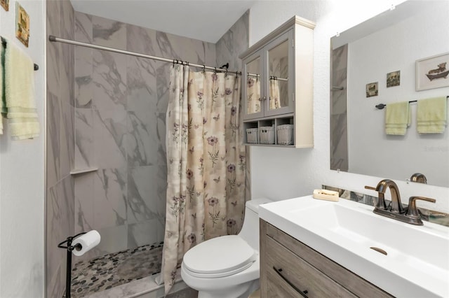 bathroom with toilet, vanity, and a shower with curtain