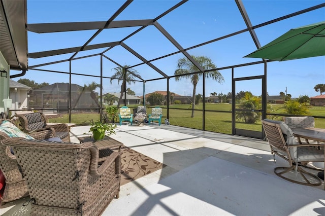 view of patio featuring glass enclosure