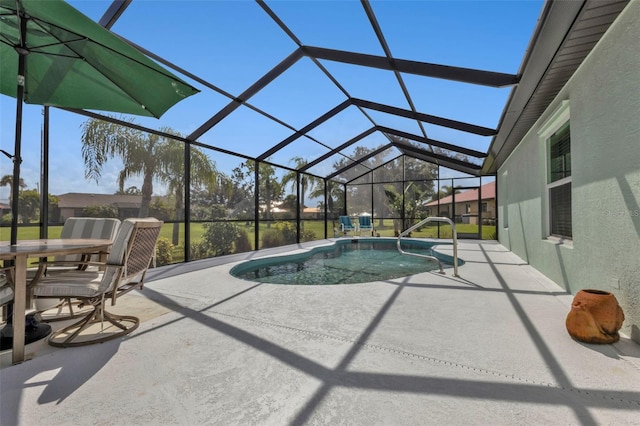 view of swimming pool with glass enclosure and a patio area