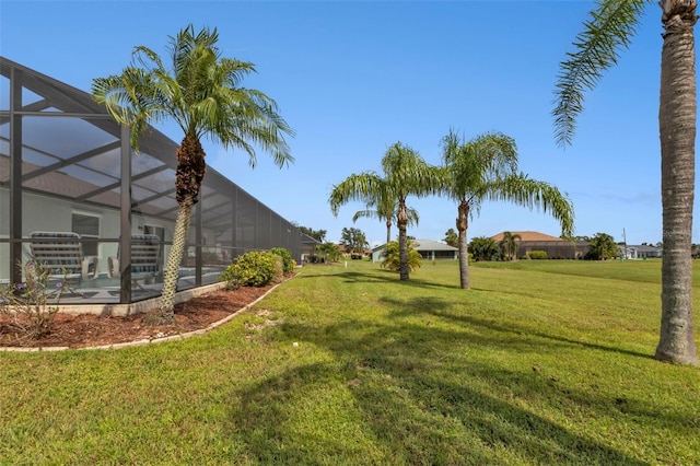 view of yard with glass enclosure and a pool