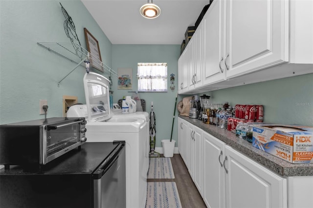 laundry room featuring washing machine and dryer and dark wood-type flooring