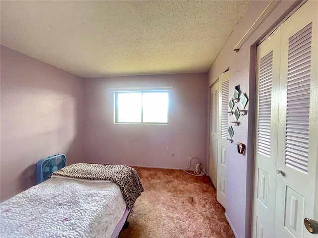 carpeted bedroom with a textured ceiling