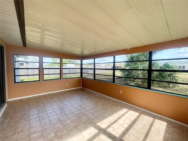 unfurnished sunroom with wood ceiling