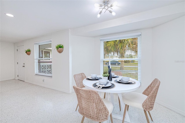 dining room with a chandelier and plenty of natural light