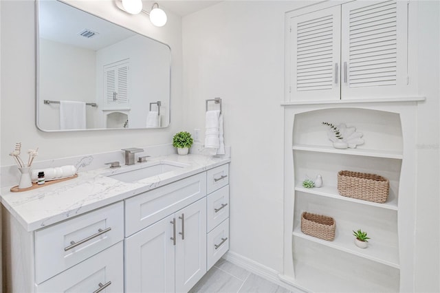 bathroom featuring tile patterned flooring and vanity