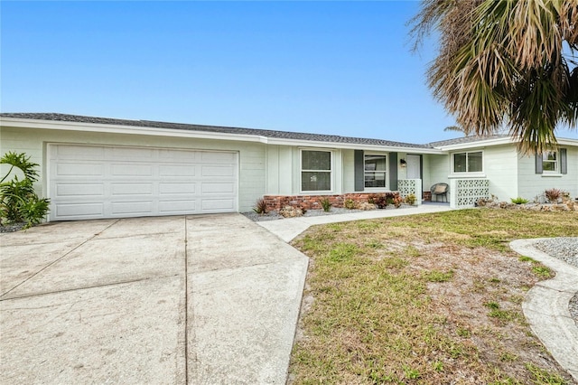 ranch-style home with a garage and a front lawn