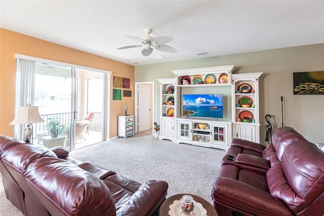 carpeted living room with ceiling fan