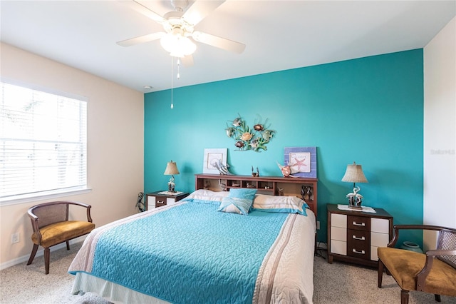 bedroom featuring ceiling fan, multiple windows, and carpet floors