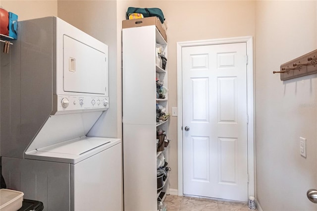 laundry room featuring stacked washer / drying machine