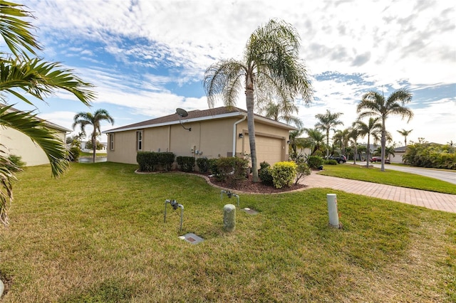 view of property exterior with a yard and a garage