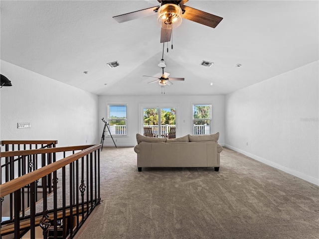 carpeted living room with ceiling fan