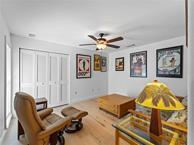 living area featuring ceiling fan and light hardwood / wood-style floors