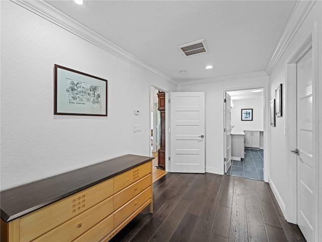 corridor featuring dark hardwood / wood-style flooring, crown molding, and a textured ceiling