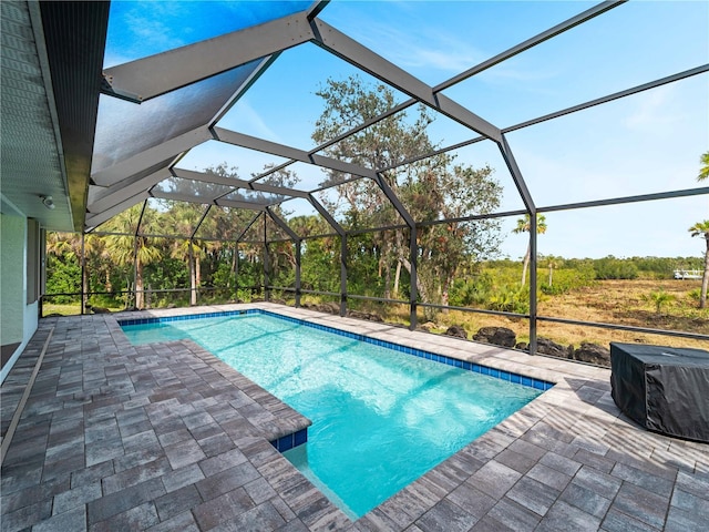 view of pool with a patio area and a lanai