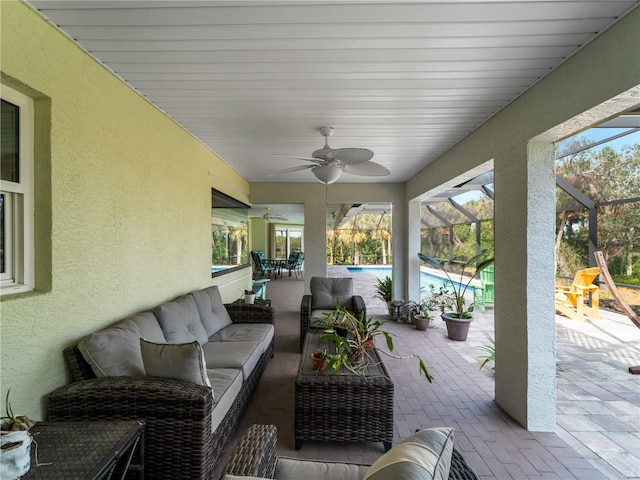 view of patio / terrace featuring ceiling fan, a lanai, and an outdoor hangout area