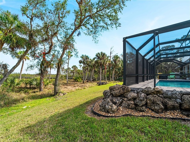 view of yard with glass enclosure