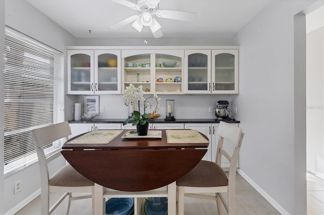 dining area with ceiling fan and light tile patterned floors