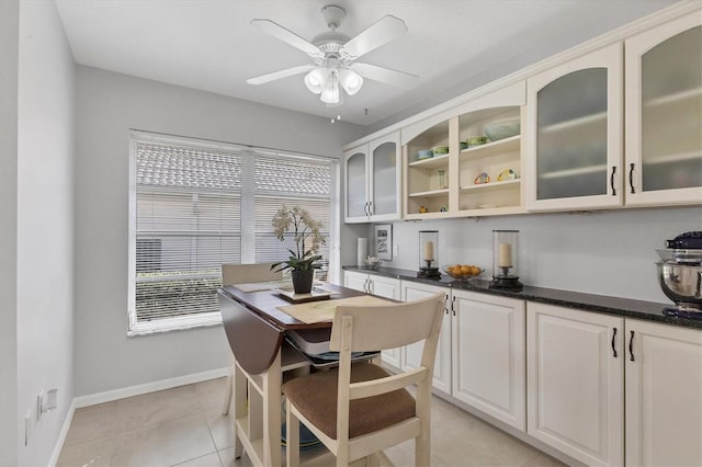 tiled dining room with ceiling fan