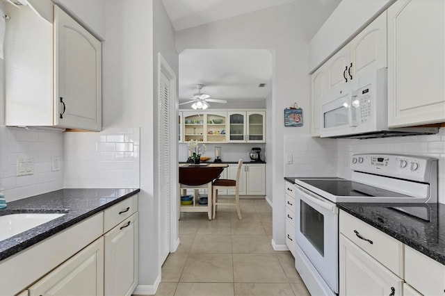 kitchen with light tile patterned flooring, white cabinetry, and white appliances