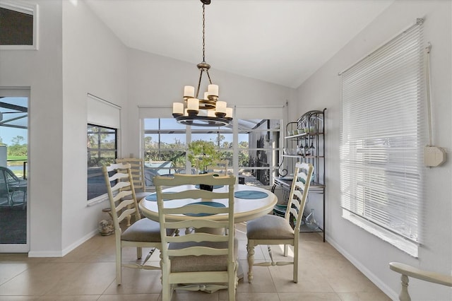 dining space featuring lofted ceiling, light tile patterned floors, and a chandelier