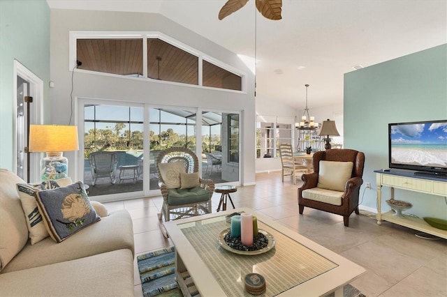 living room featuring ceiling fan with notable chandelier, light tile patterned floors, and high vaulted ceiling