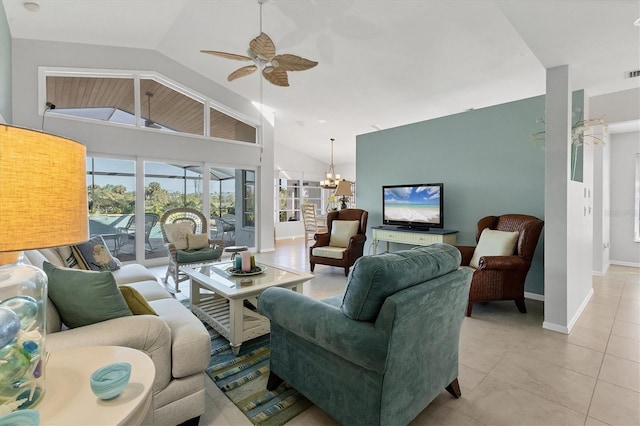 living room with ceiling fan with notable chandelier, lofted ceiling, and light tile patterned flooring