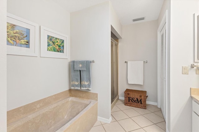 bathroom featuring vanity, tile patterned floors, and plus walk in shower