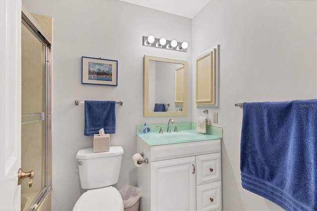 full bathroom featuring toilet, vanity, and shower / bath combination with glass door