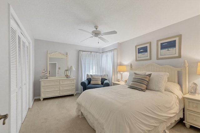 carpeted bedroom featuring a textured ceiling, ceiling fan, and a closet