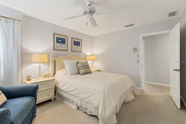 bedroom with ceiling fan and light colored carpet