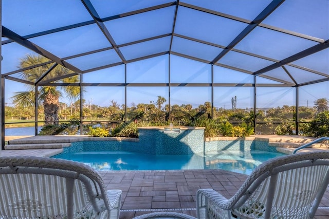 view of swimming pool featuring glass enclosure, a patio area, and a hot tub