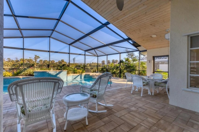 view of patio / terrace featuring a lanai and ceiling fan