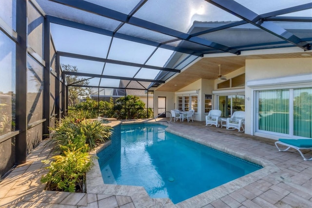 view of pool featuring a lanai, ceiling fan, and a patio area