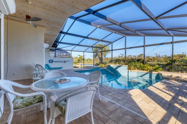 view of pool featuring ceiling fan, a lanai, and a patio