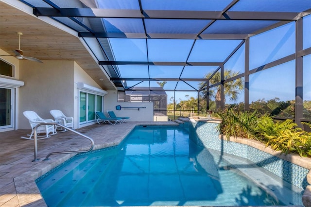 view of swimming pool featuring a lanai, ceiling fan, and a patio area