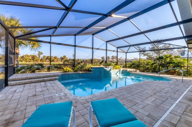 view of swimming pool with pool water feature, a patio area, and glass enclosure