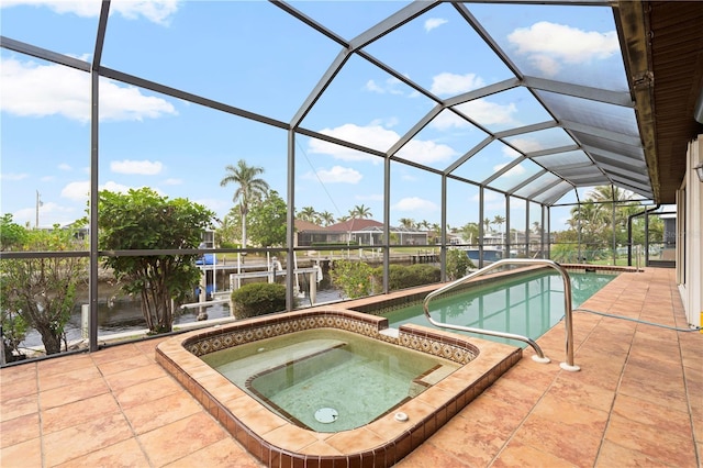 view of swimming pool featuring a lanai, a patio area, and an in ground hot tub