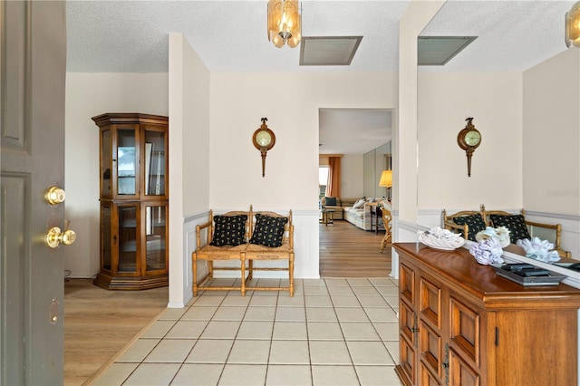 entrance foyer with light tile patterned floors and a textured ceiling