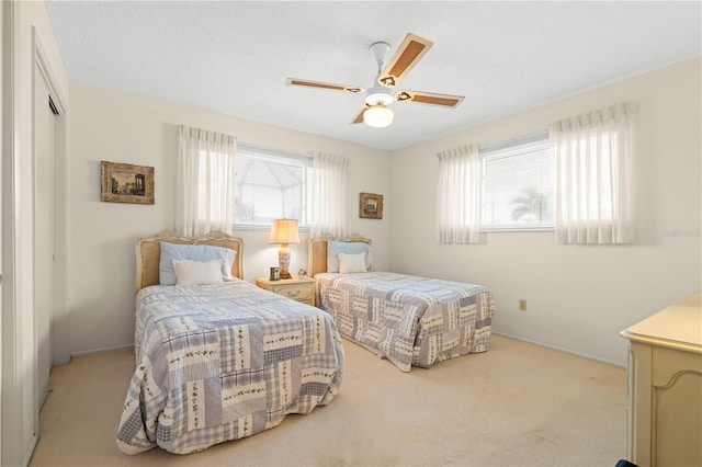 carpeted bedroom featuring ceiling fan