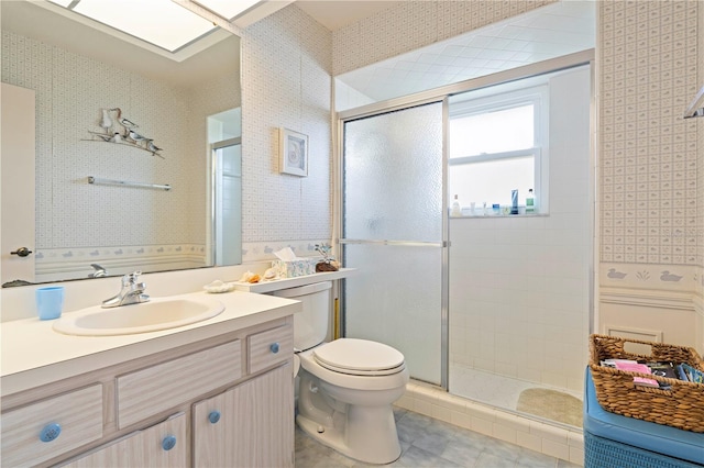 bathroom with toilet, vanity, and walk in shower