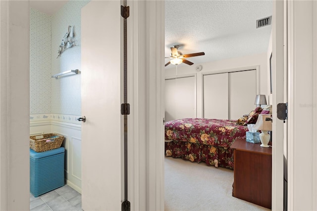 bedroom with a textured ceiling and ceiling fan