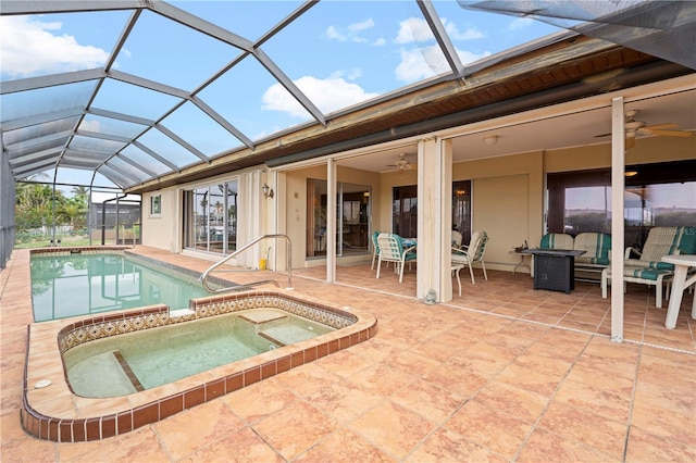 view of swimming pool featuring an in ground hot tub, a lanai, and a patio