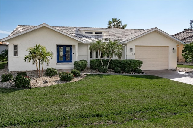 view of front of house featuring a garage, a front lawn, and french doors