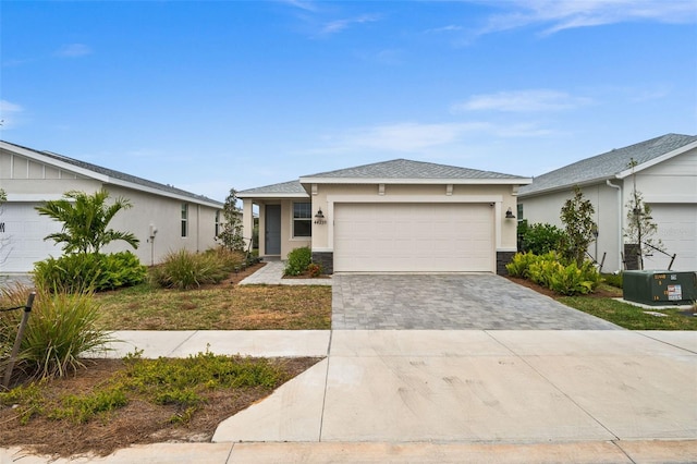 ranch-style home featuring central AC unit and a garage