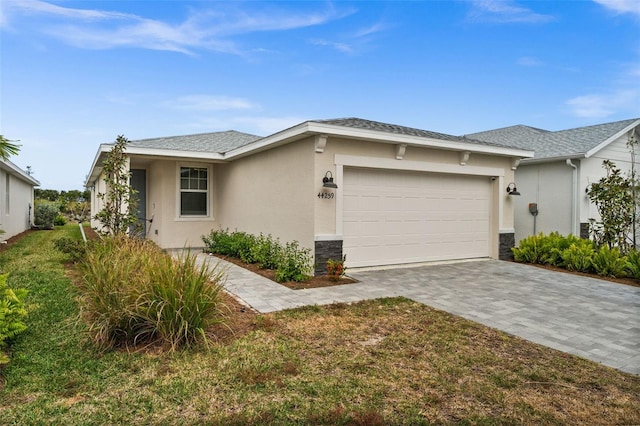 view of front of home with a front yard and a garage