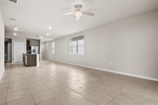 unfurnished living room with ceiling fan and light tile patterned floors