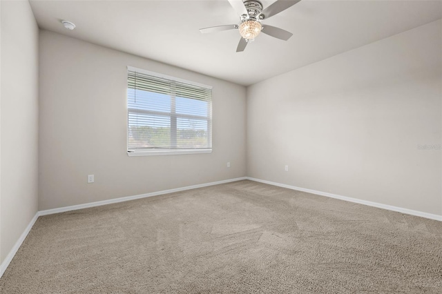 carpeted spare room featuring ceiling fan