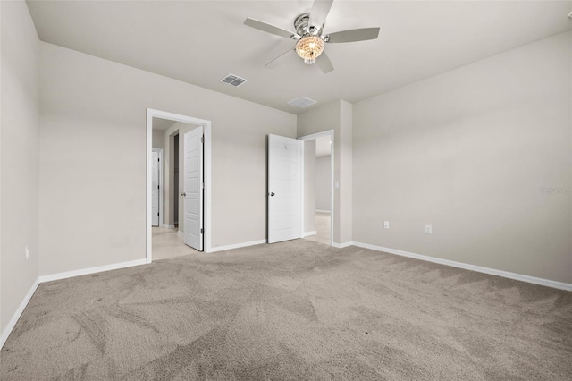 unfurnished bedroom featuring light carpet and ceiling fan