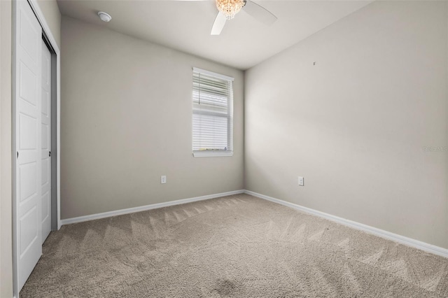 unfurnished bedroom with ceiling fan, carpet, and a closet