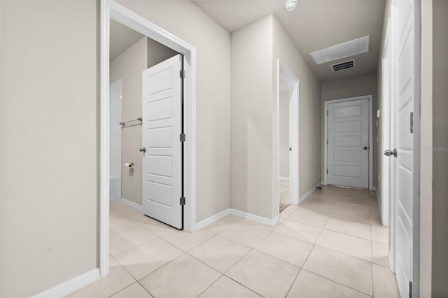 corridor featuring light tile patterned floors